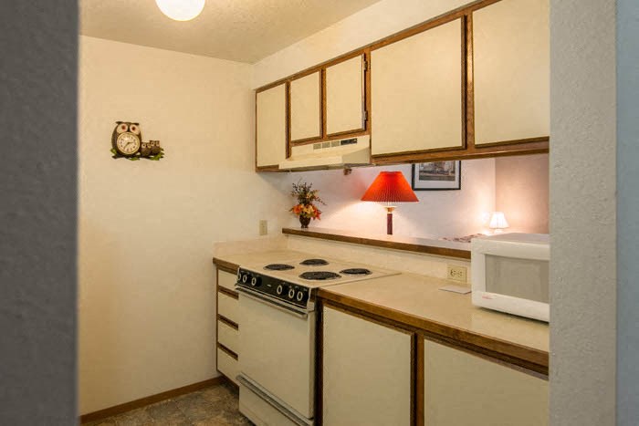 a kitchen with a stove and a microwave