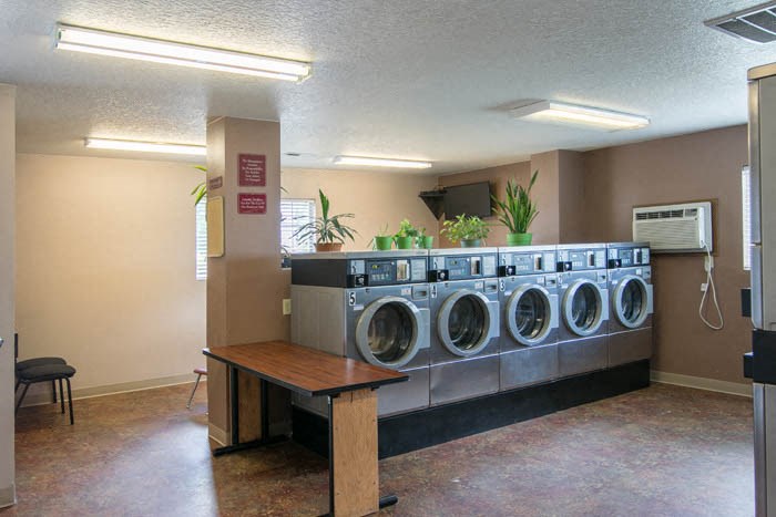 a group of washing machines in a laundry room