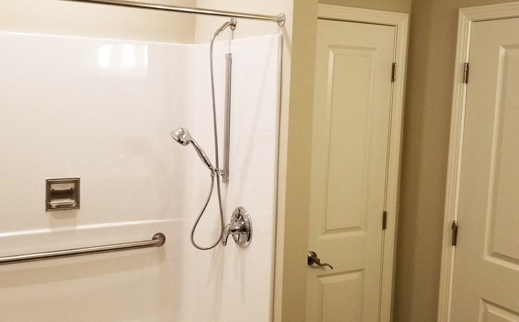 a bathroom with a shower and a door