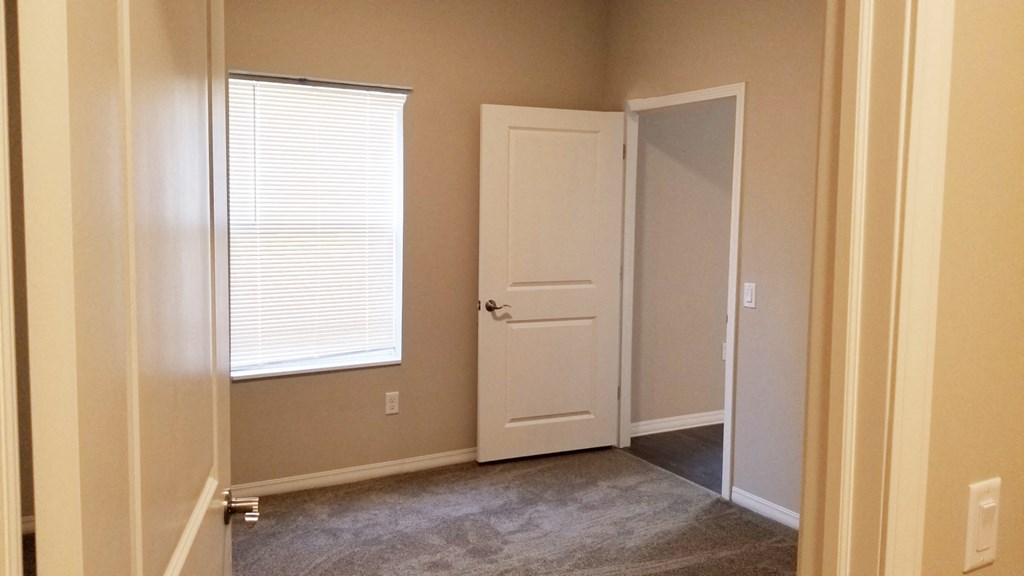 a room with a door and a window and a closet