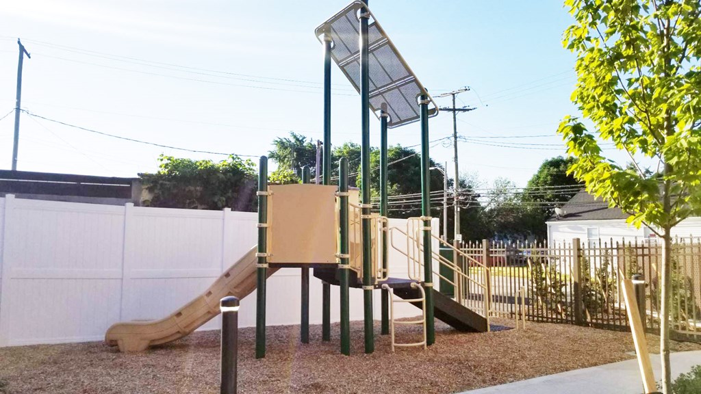 a childrens playground with a slide and