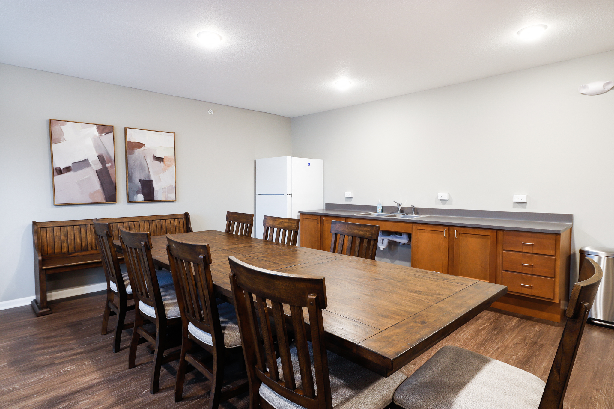 a dining room with a wooden table and chairs