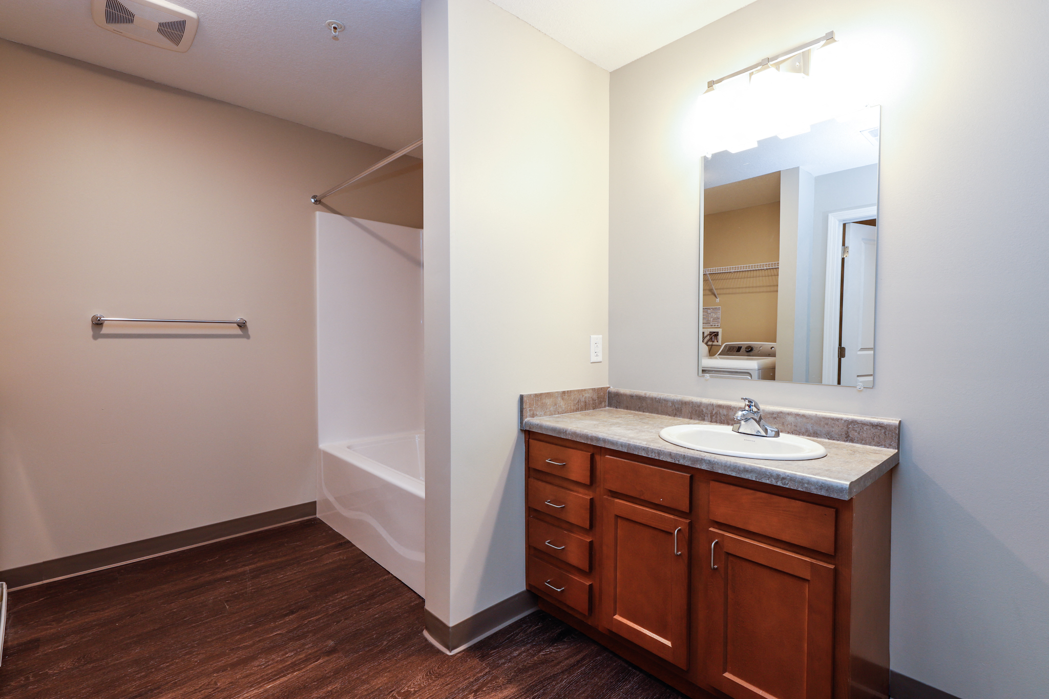 a bathroom with a sink and a mirror and a shower