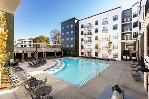 a swimming pool in front of an apartment building