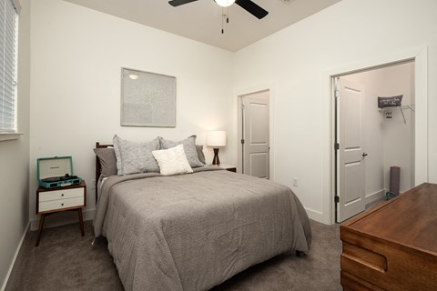 a bedroom with a large bed and a ceiling fan