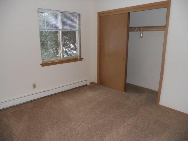 an empty room with a door and a window