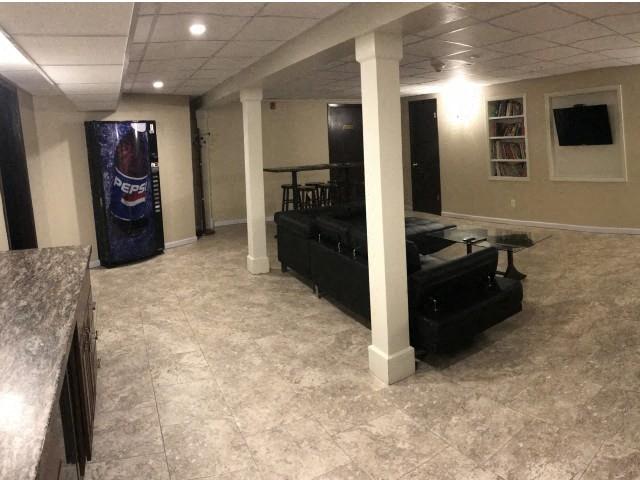a living room with a black couch and a table