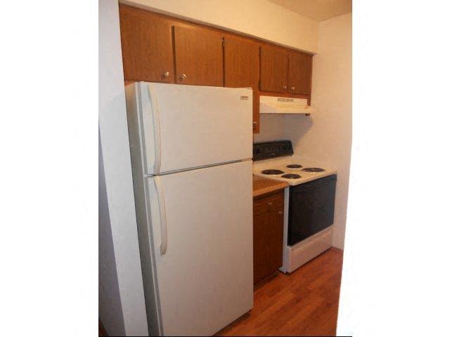 a kitchen with a white refrigerator and a stove