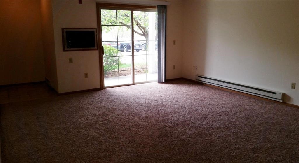 an empty living room with a sliding glass door