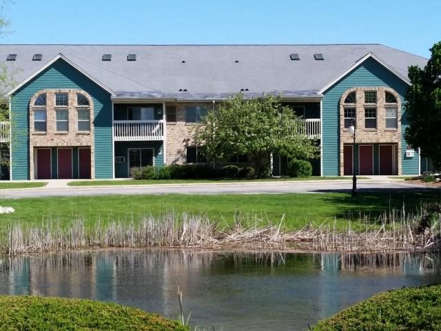 a building with a pond in front of it