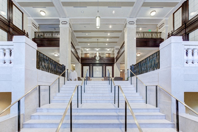 the lobby of a building with stairs and a large staircase
