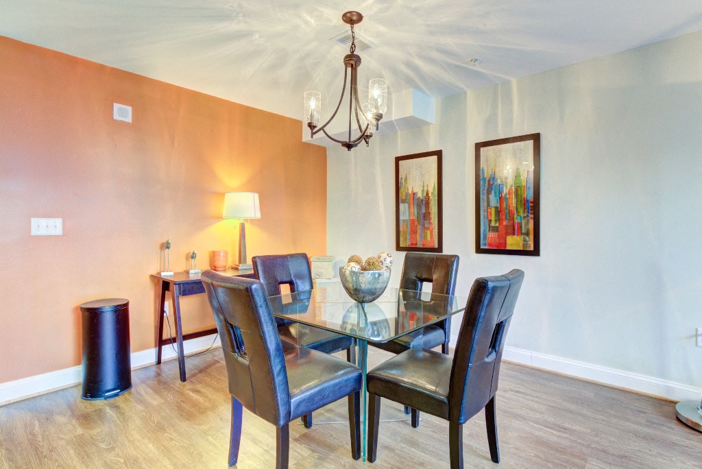 a dining room with a table and chairs and a chandelier