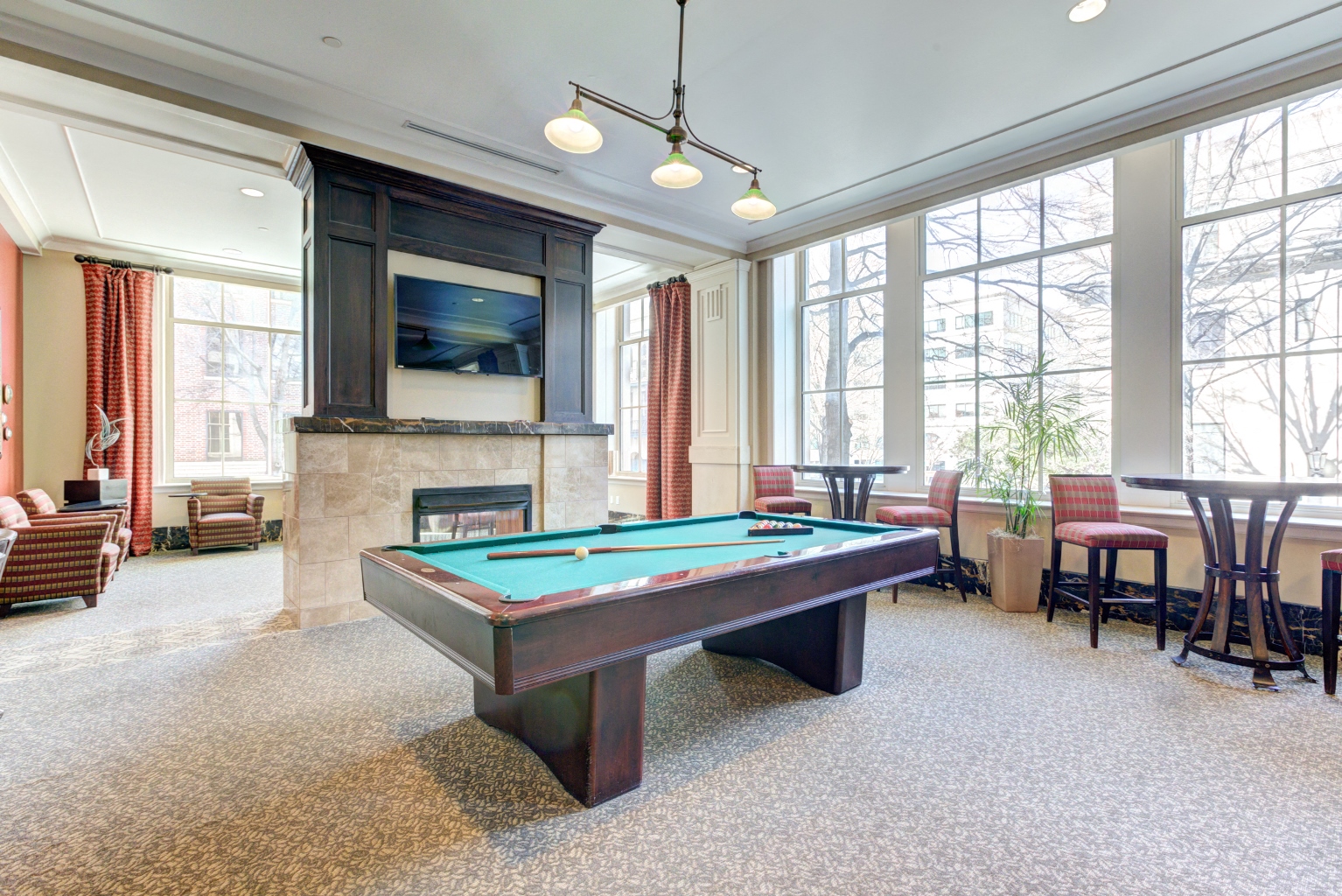 a game room with a pool table and a television