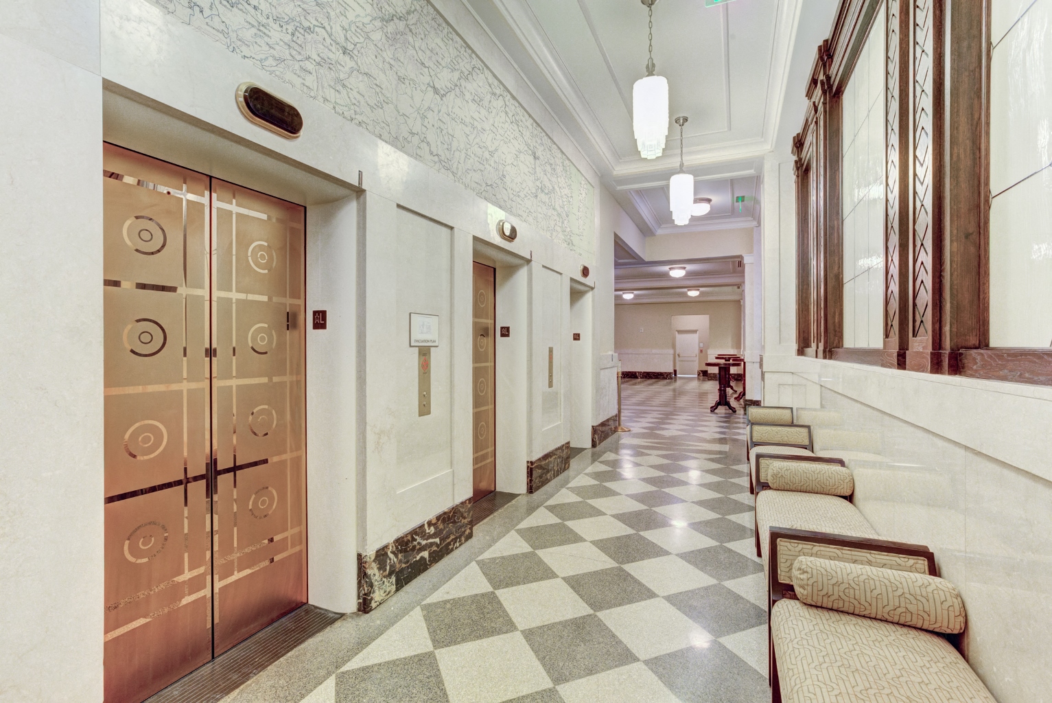 a hallway of elevators and doors in a building