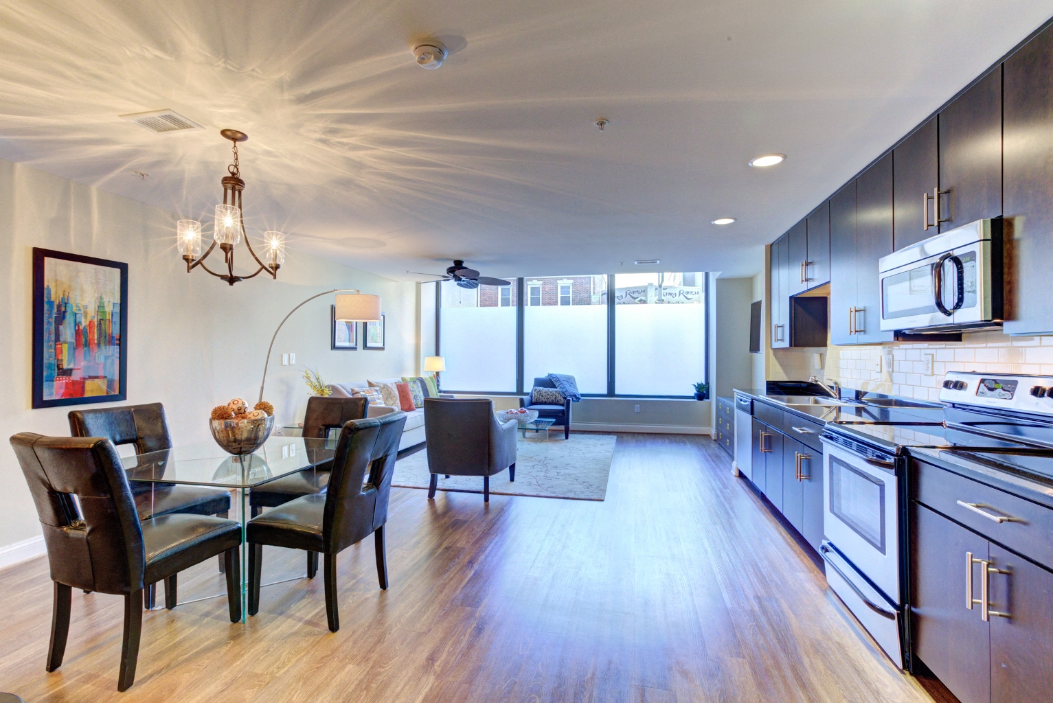 a kitchen and dining room area with a table and chairs