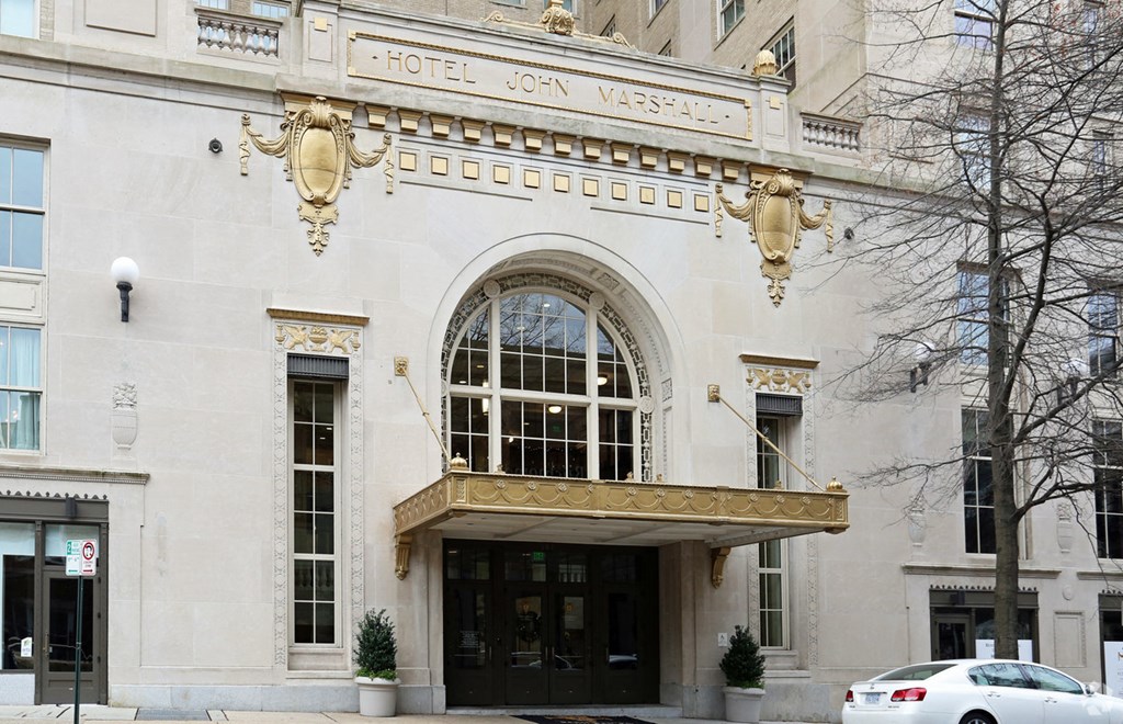 the facade of a hotel with a large window and a balcony