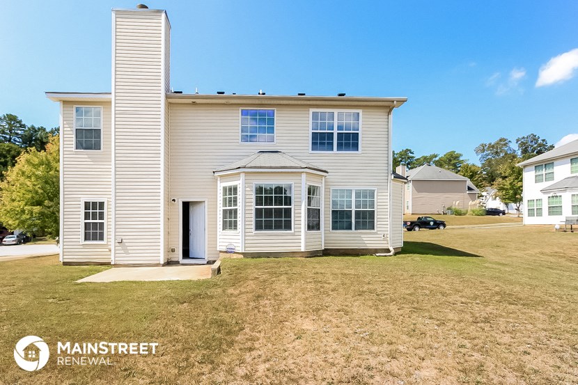a white house with a lawn in front of it