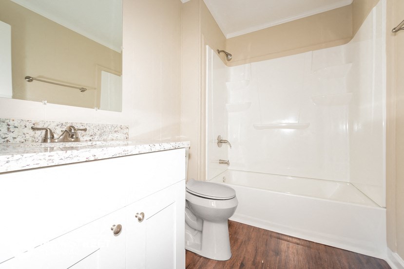 a bathroom with a sink and a toilet and a shower