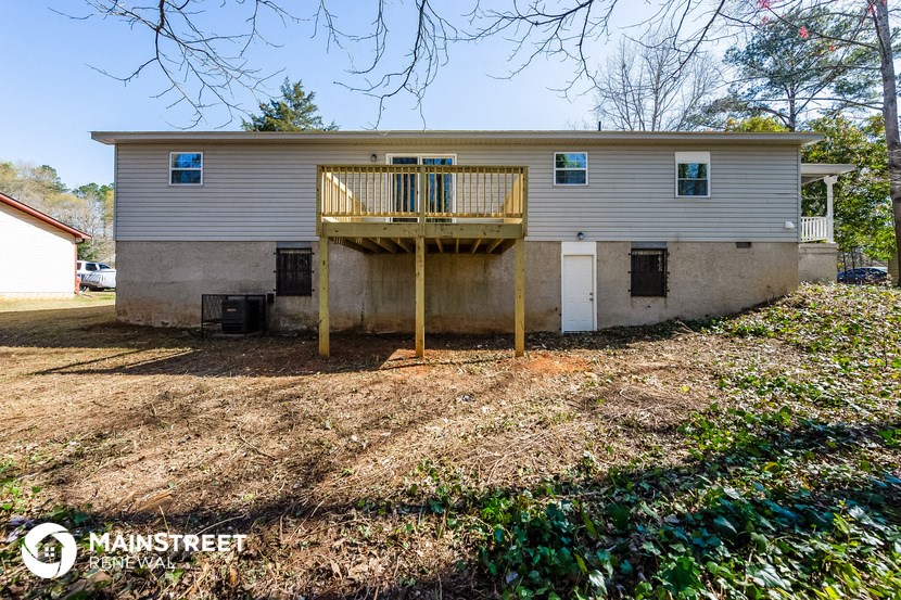 a white house with a porch and a deck
