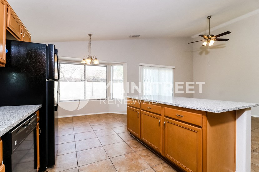 a kitchen with a counter top and a refrigerator