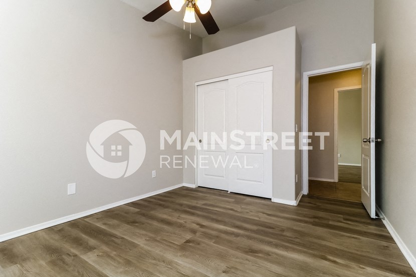 a bedroom with a white door and a closet