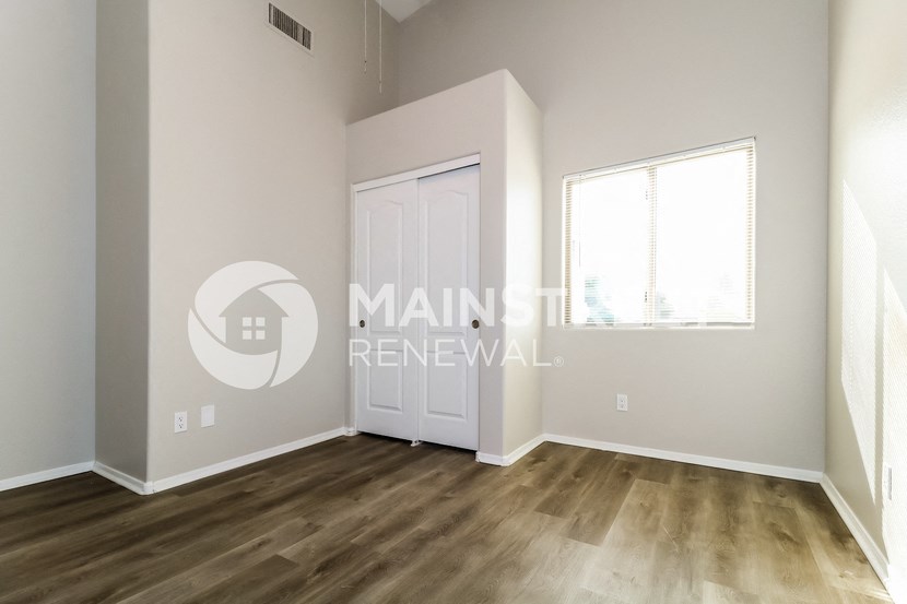 a bedroom with a closet and a door