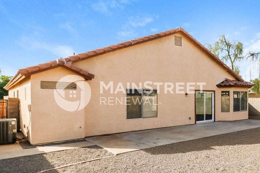 a front view of the front entrance of a building with a driveway and a door