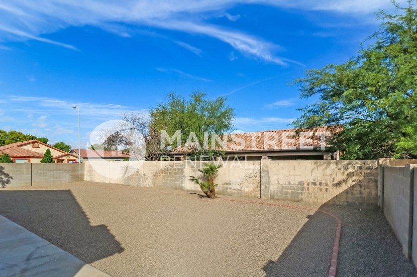a view of the street sign in front of a concrete wall with a