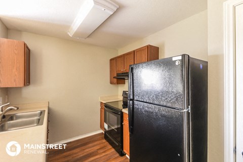 a kitchen with a refrigerator and a sink