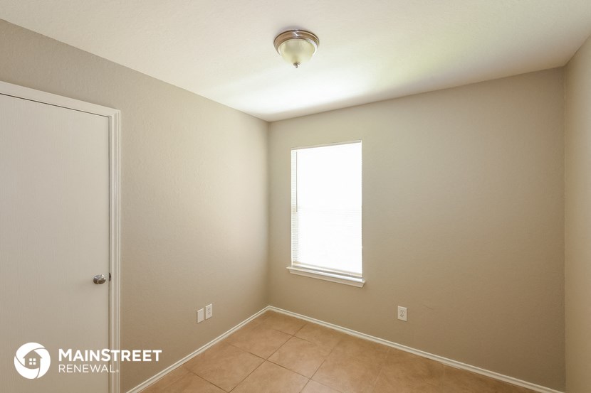 the interior of a room with a ceiling light and a window