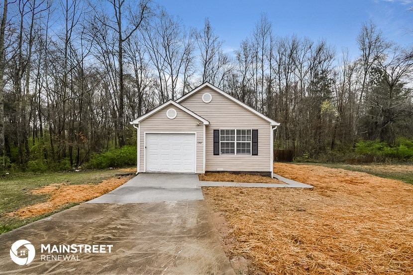a garage with a driveway in front of a house