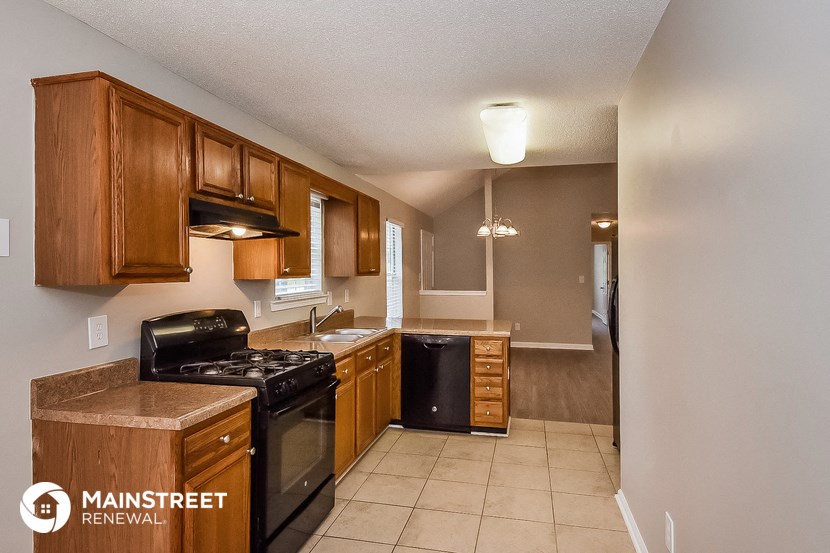 a kitchen with black appliances and wooden cabinets