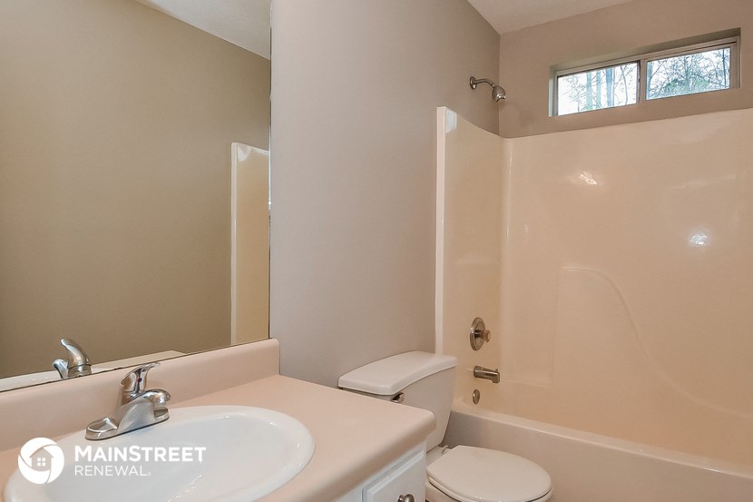 a bathroom with a toilet and a sink and a shower