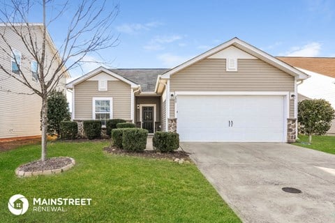 a home with a white garage door and a driveway
