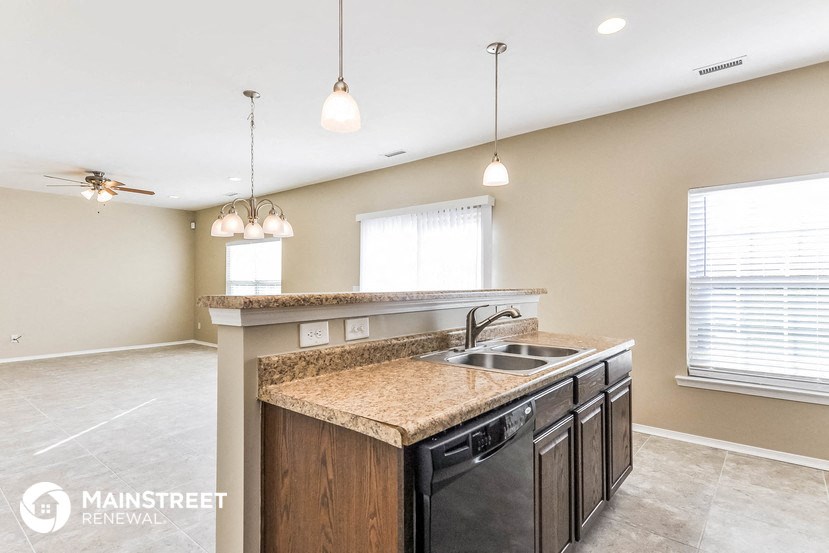 a kitchen with a dishwasher and a counter top with a sink