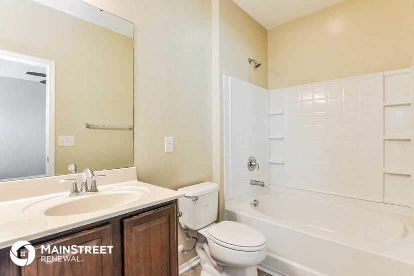 a bathroom with a sink toilet and a tub