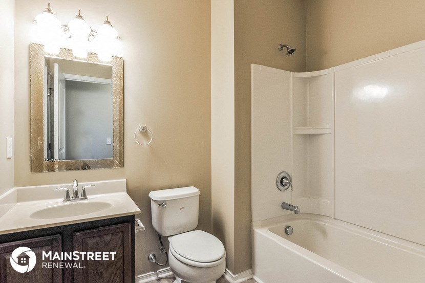 a bathroom with a sink toilet and a bath tub