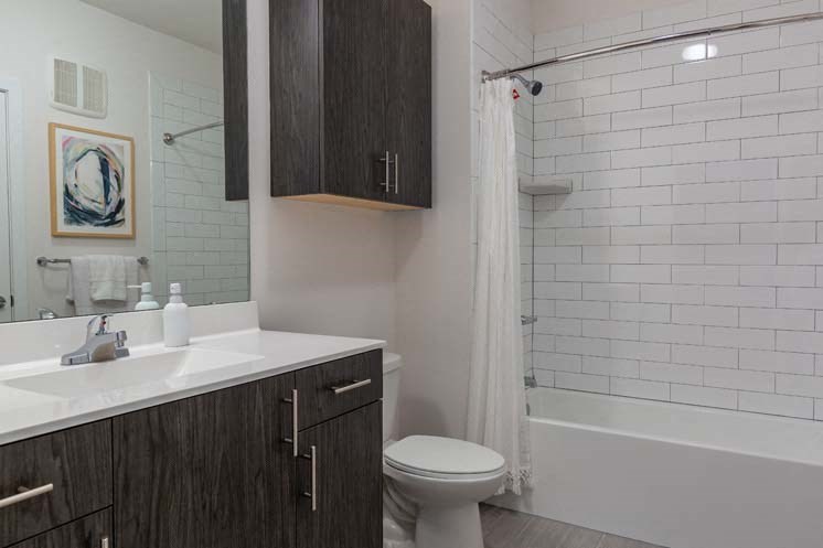 a bathroom with a toilet and a sink and a shower