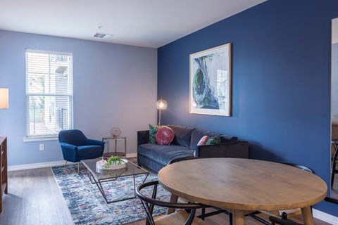 a living room with a blue wall and a round table