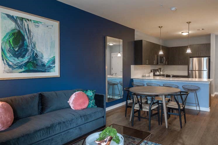 a living room and kitchen with a table and couch