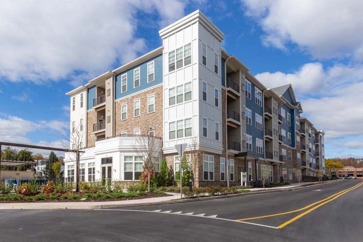 a large apartment building on the corner of a street