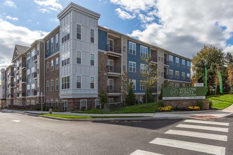 an apartment building on the corner of a street
