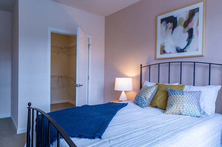 a bedroom with a bed and a bathroom with a shower