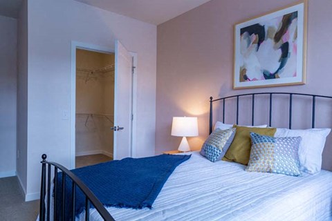 a bedroom with a bed and a bathroom with a shower