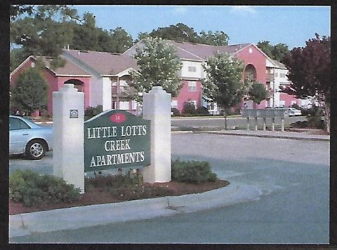 Little Lots Creek Apartments sign in front of a building.