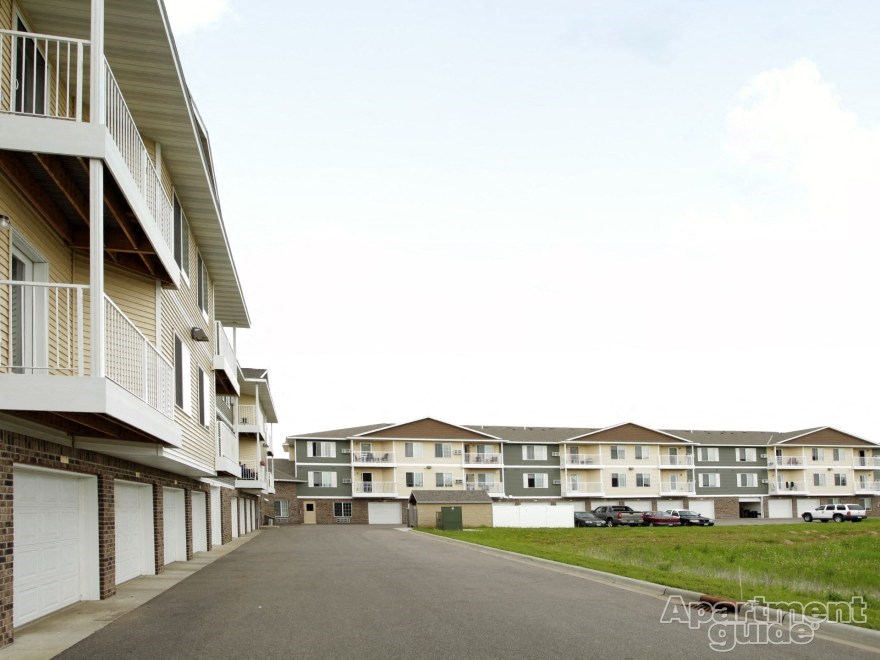 a row of apartment buildings on the side of a road