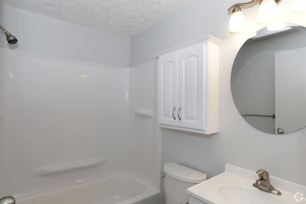 a bathroom with a sink toilet and a mirror