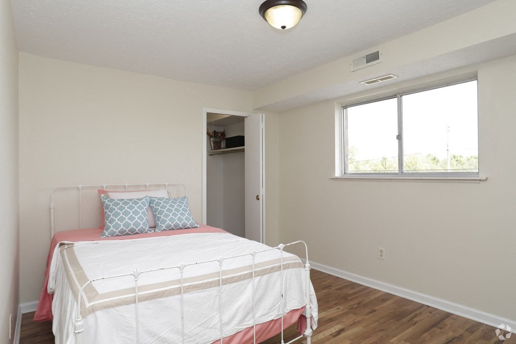 a bedroom with a bed and a window