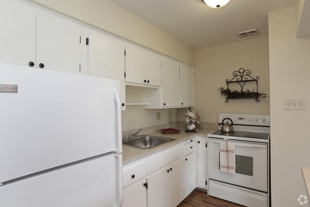 a kitchen with white appliances and white cabinets