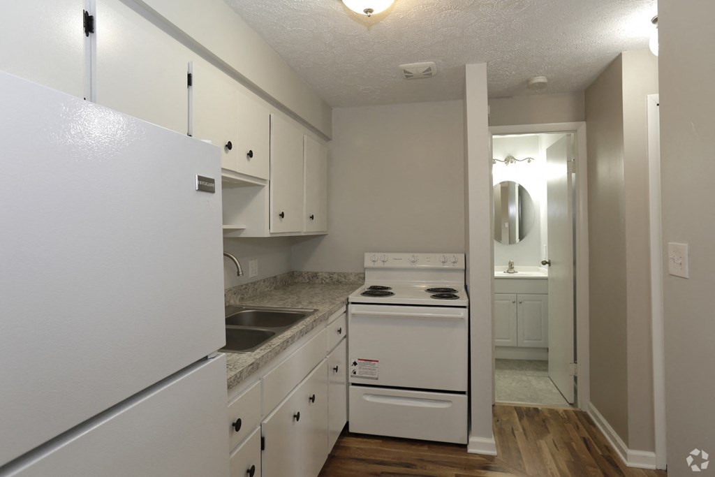 a kitchen with white appliances and white cabinets